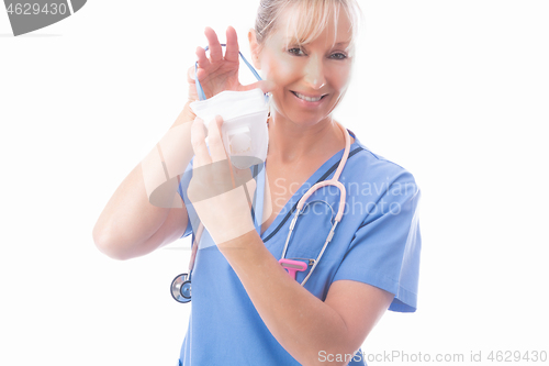 Image of Nurse putting on a respirator P2 N95 respirator mask