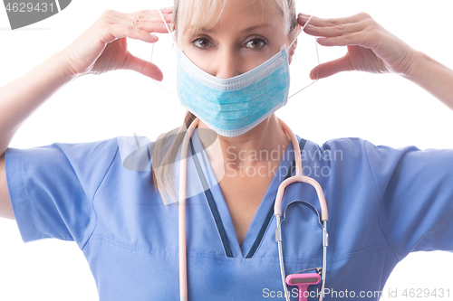 Image of Nurse or doctor putting on PPE a medical face mask