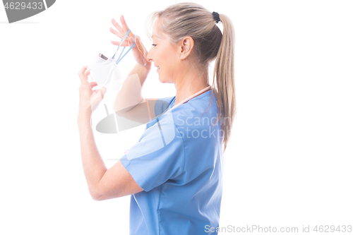 Image of Nurse or healthcare worker putting on a N95 mask