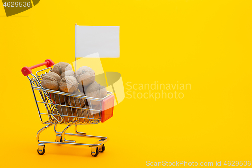 Image of Walnuts are in the grocery cart, a flag with a white price tag is stuck