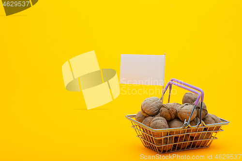 Image of Walnuts are in the grocery basket, a flag with a white price tag is stuck