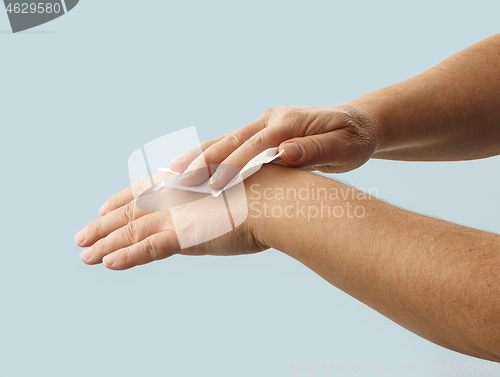 Image of hands are cleaned with a disinfectant wipe