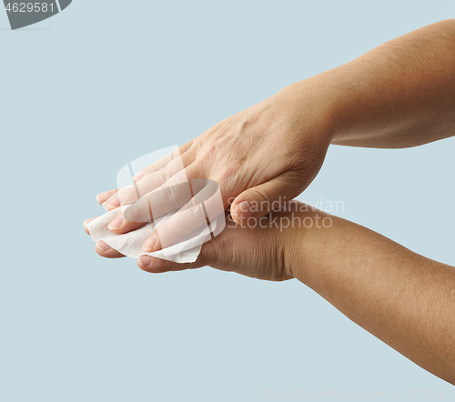 Image of hands are cleaned with a disinfectant wipe