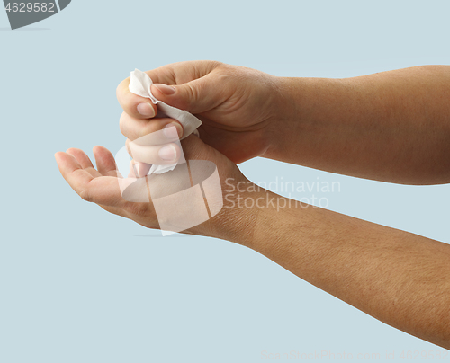 Image of hands are cleaned with a disinfectant wipe