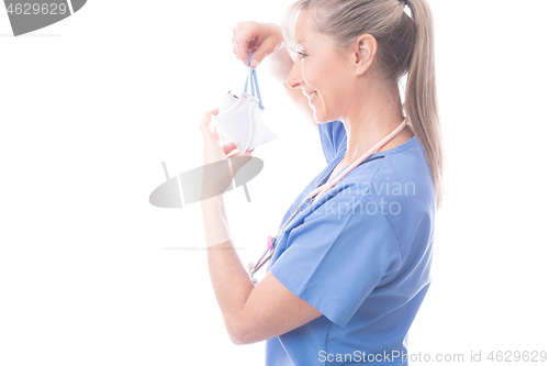 Image of Doctor of nurse putting on a surgical mask