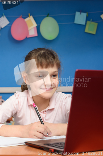 Image of Happy girl studying in quarantine at home online