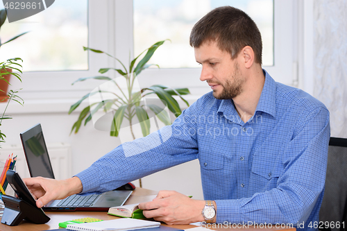 Image of Office employee picks up the a phone