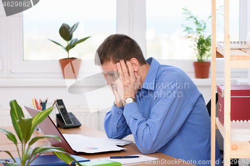 Image of A man watching a report with a bad investment