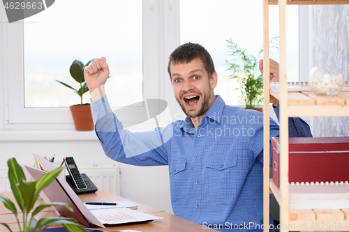 Image of Businessman in the office is very happy about a successful deal