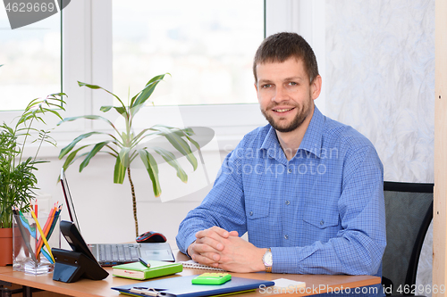 Image of Successful business man in the office at the workplace