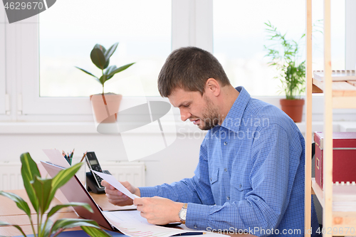 Image of Office Specialist Reads Bad Investment a Report