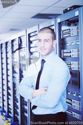 Image of young it engeneer in datacenter server room