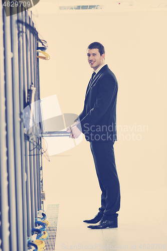 Image of young engeneer in datacenter server room