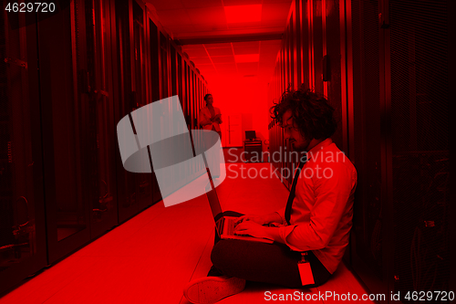 Image of Team of young technicians working together on servers