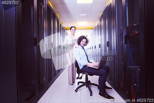 Image of Team of young technicians working together on servers