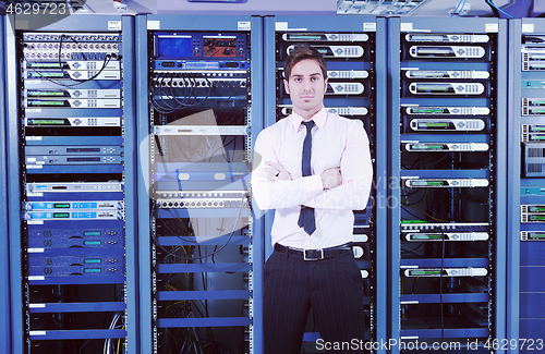 Image of young it engeneer in datacenter server room