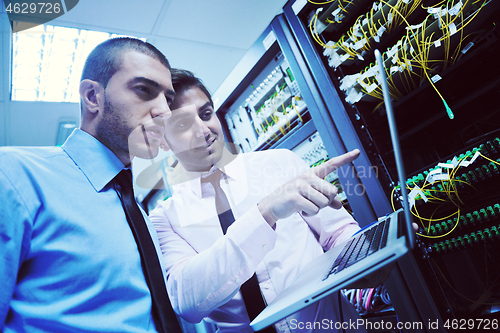 Image of it engineers in network server room