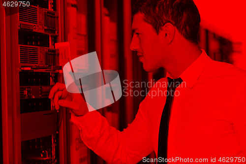 Image of young engeneer in datacenter server room