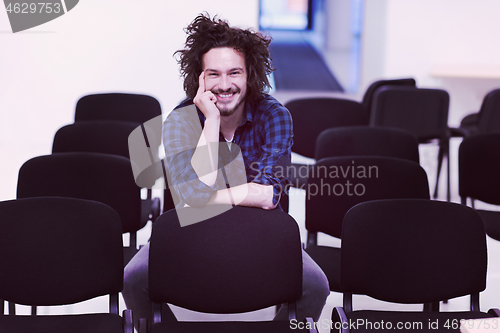 Image of A student sits alone  in a classroom