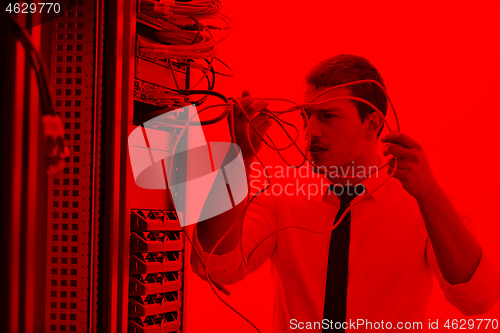 Image of young engeneer in datacenter server room