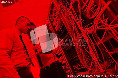 Image of it engineers in network server room