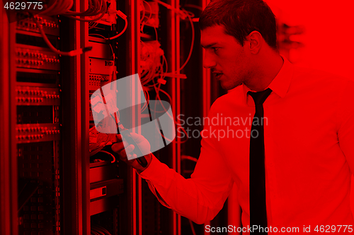 Image of young it engeneer in datacenter server room