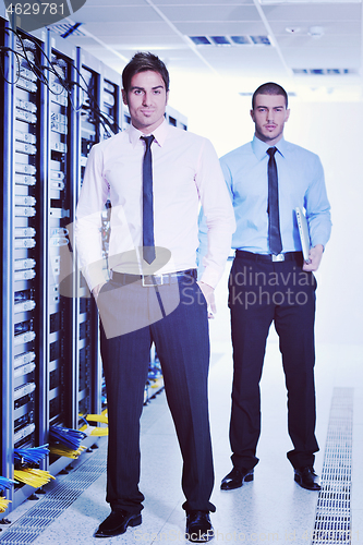 Image of it engineers in network server room