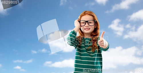 Image of red haired student girl in glasses over blue sky