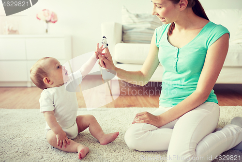 Image of happy mother and baby playing at home