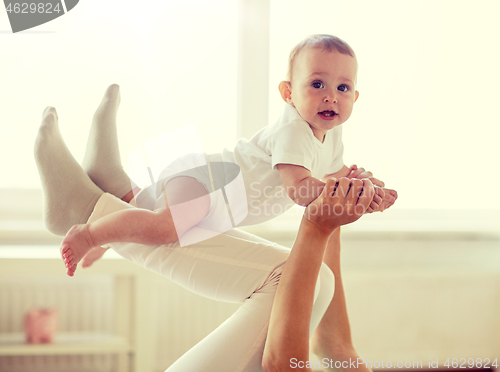 Image of mother playing with baby at home