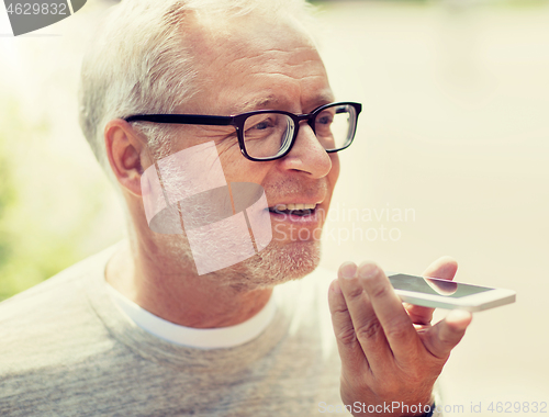 Image of old man using voice command recorder on smartphone