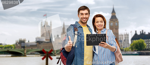 Image of couple of tourists with tablet computer in london