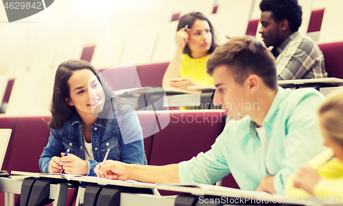 Image of group of students with notebooks in lecture hall