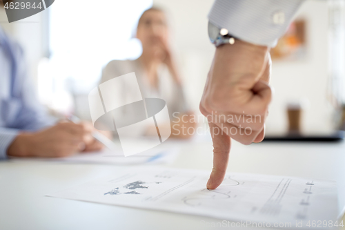 Image of close up of businessman with charts at office