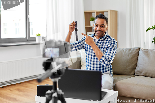 Image of male video blogger with smart watch videoblogging