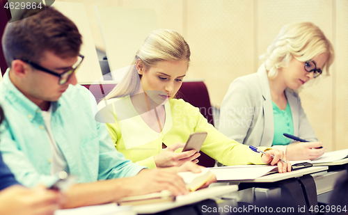 Image of student girl with smartphones at lecture