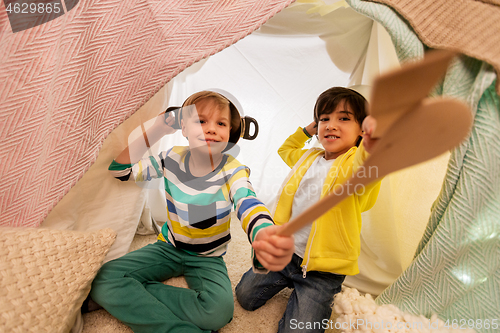 Image of boys with pots playing in kids tent at home