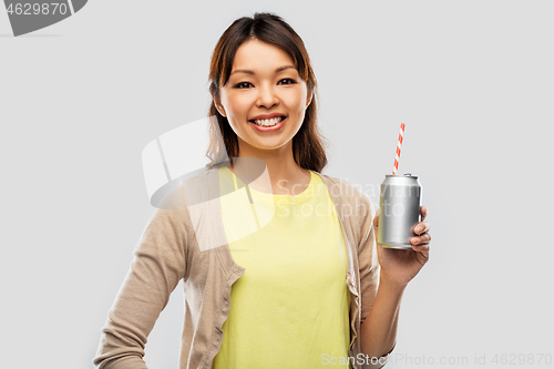 Image of happy asian woman with can drink