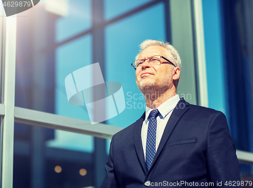 Image of senior businessman on city street