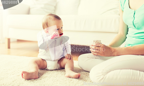 Image of mother and baby with spoon eating puree at home