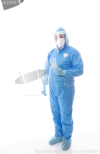 Image of Healthcare worker in full PPE holding swabs for coronavirus pandemic