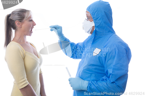 Image of A woman getting a throat swab for coronavirus COVID-19 or influe