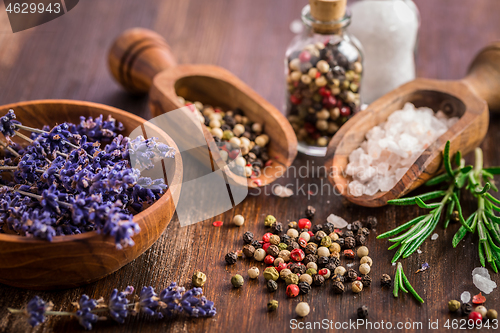 Image of Salt, pepper with rosamary and lavender on wooden background