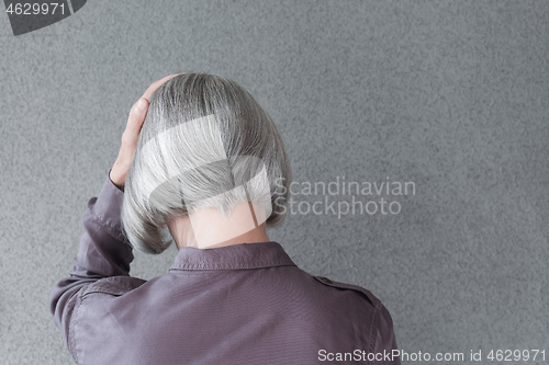 Image of Upset gray-haired woman