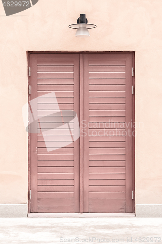 Image of Pink building with a wooden door