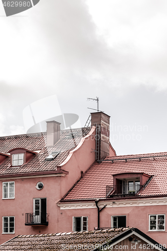 Image of Tiled rooftops of pink European buildings