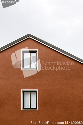 Image of Facade and windows of an orange house