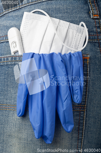 Image of Facial mask, thermometer and latex glove in back pocket