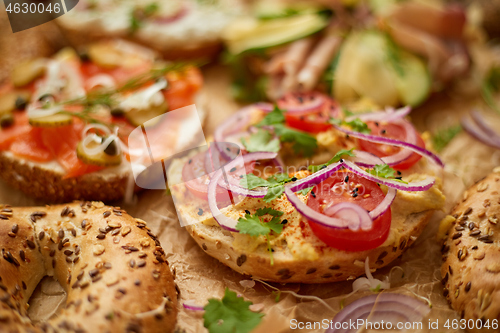 Image of Composition of various homemade bagels sandwiches with sesame and poppy seeds