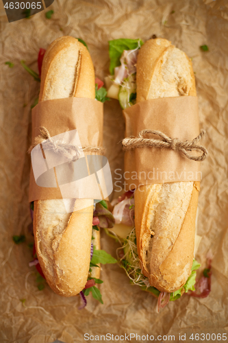 Image of Tasty homemade sandwiches Baguettes with various healthy ingredients. Breakfast take away concept